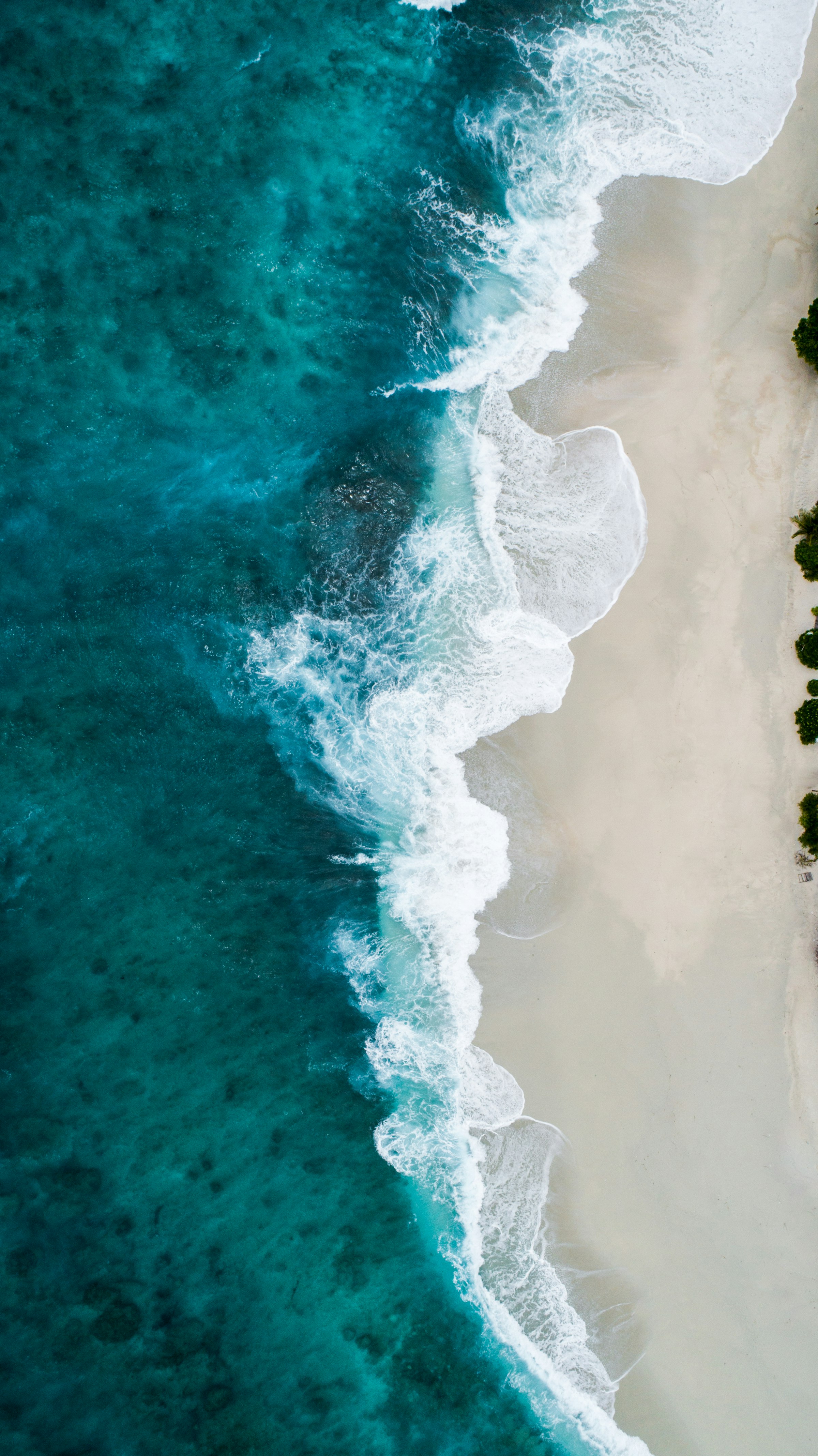 Aerial view of gulf water meeting sand